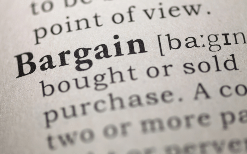 A dictionary page open at the entry for the word "Bargain"