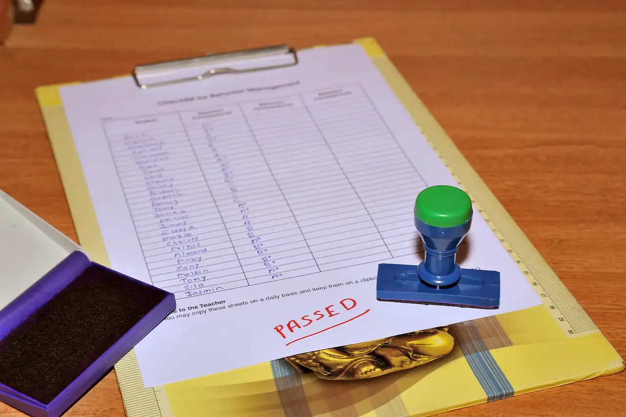 A form on a clipboard with a rubber stamp