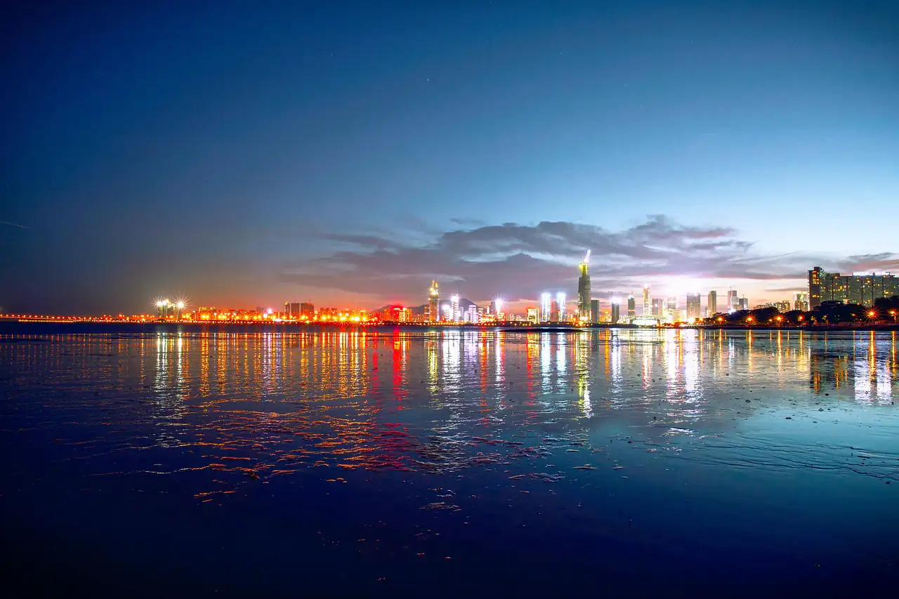 A city skyline lit up across the water