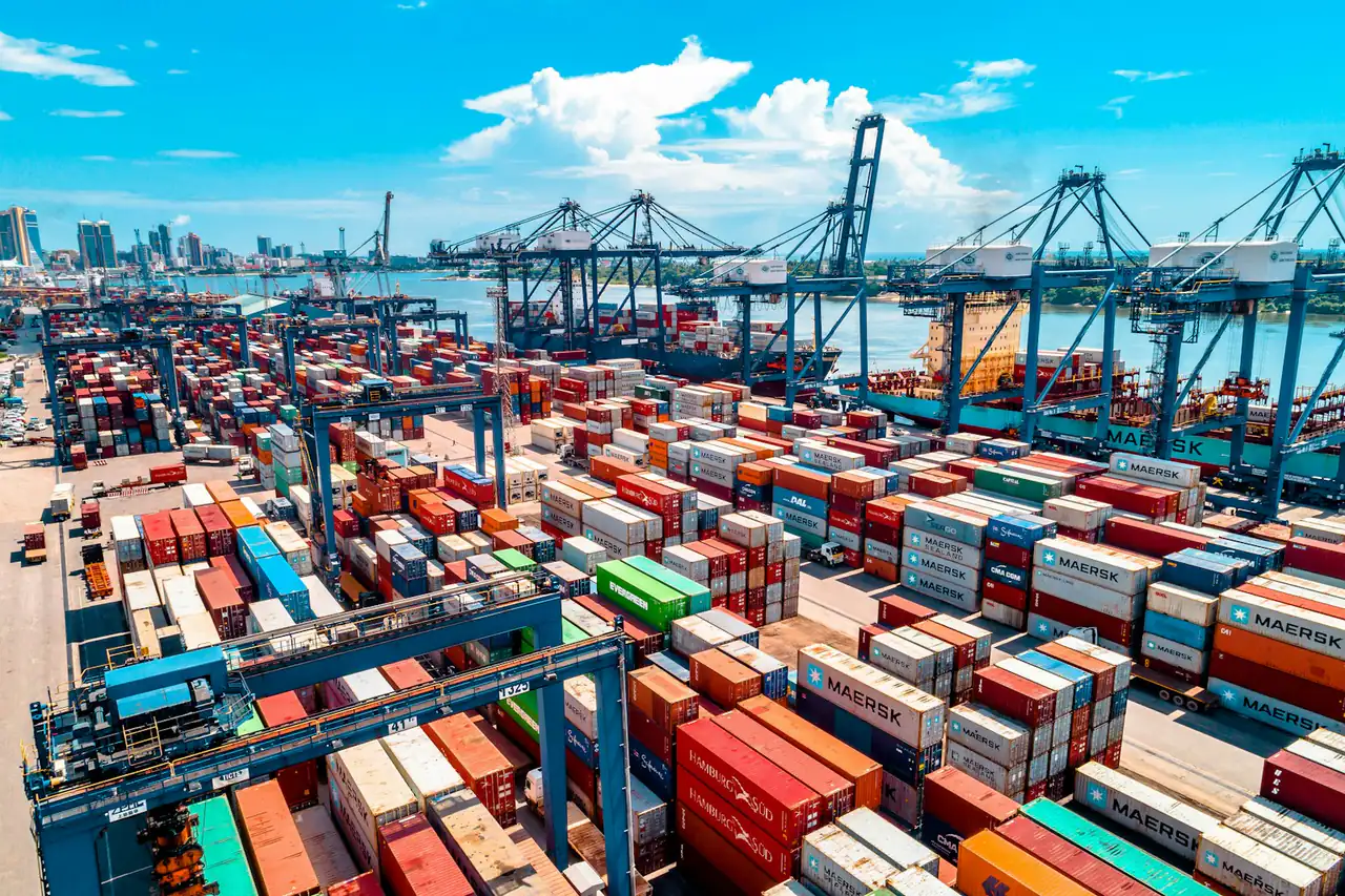 Aerial view of a container yard and quay cranes at a port