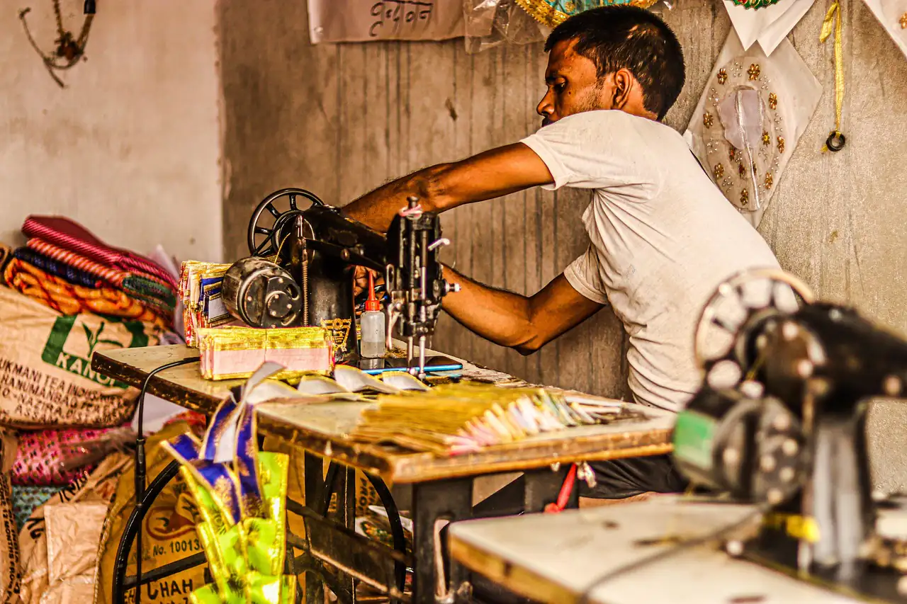 A tailor at his machine in a small Indian workshop