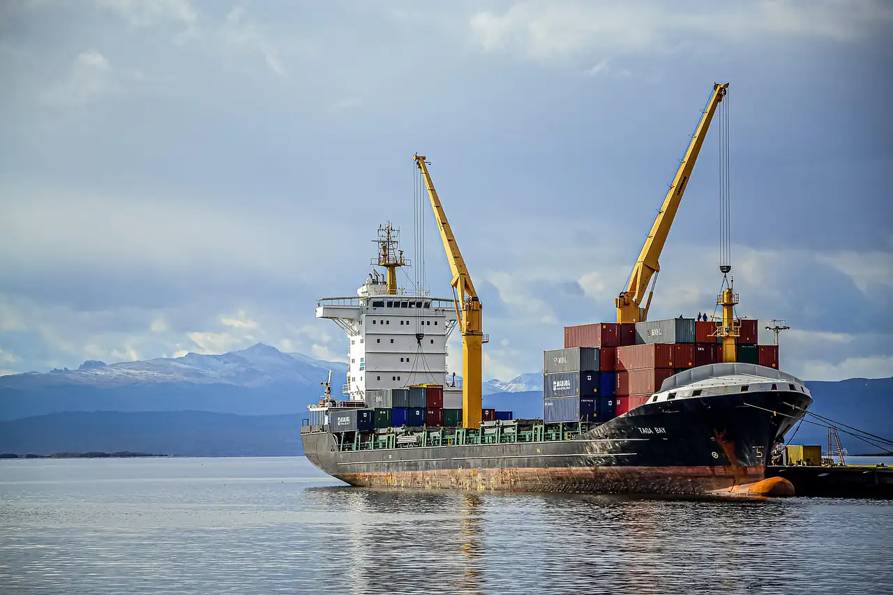 A cargo ship being loaded at a quay