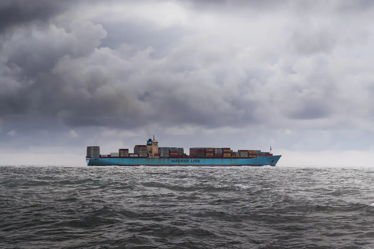 A container ship under grey skies