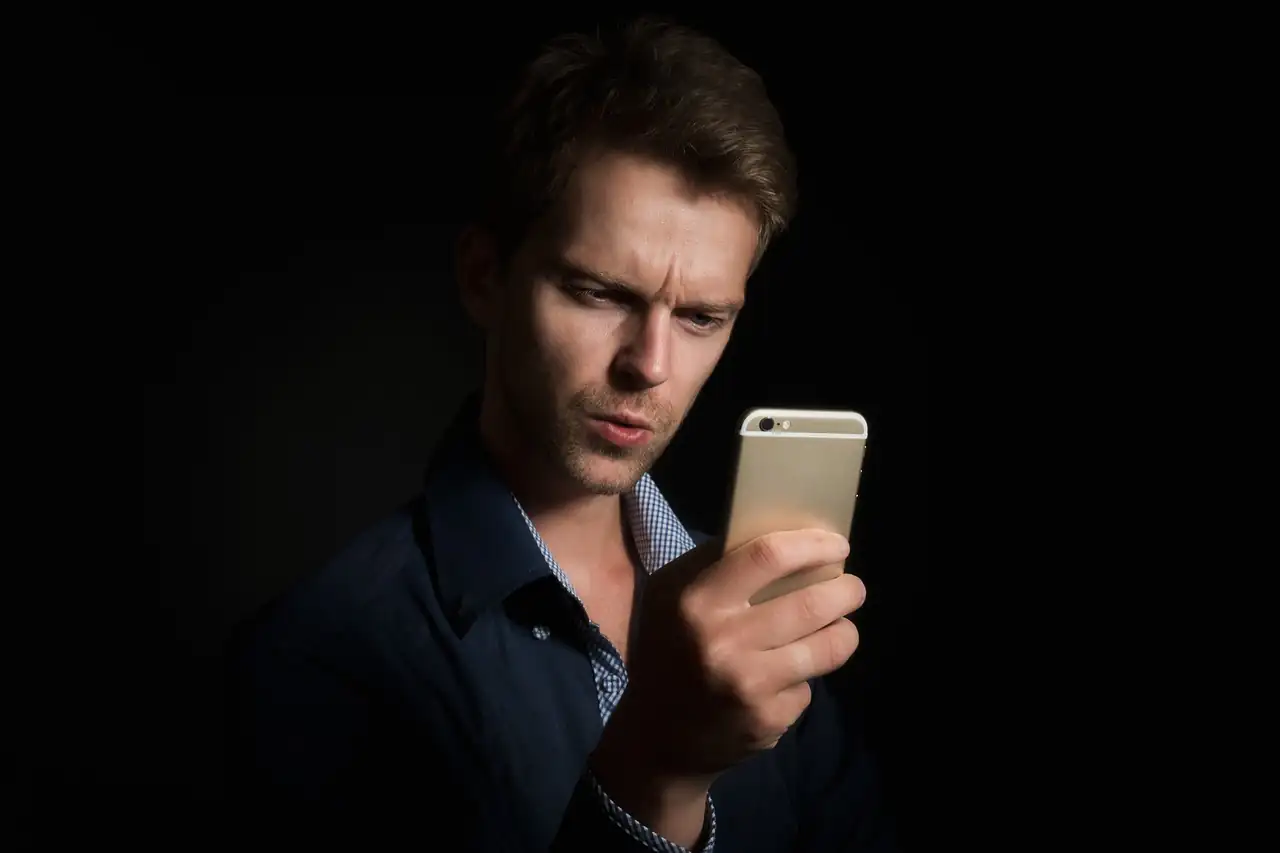 A man frowning at his phone