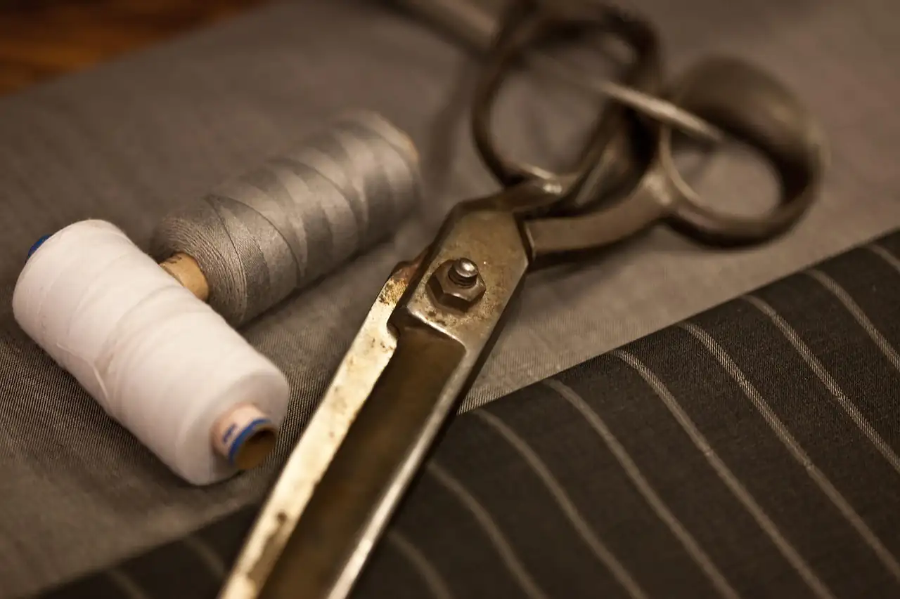 Tailor's shears and thread on cloth