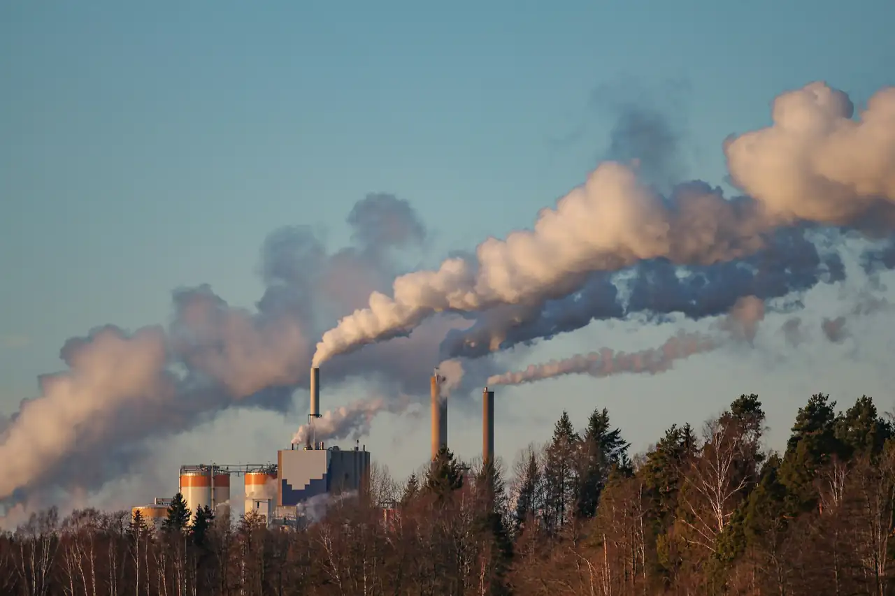 Smoke rising from the chimneys of an industrial plant