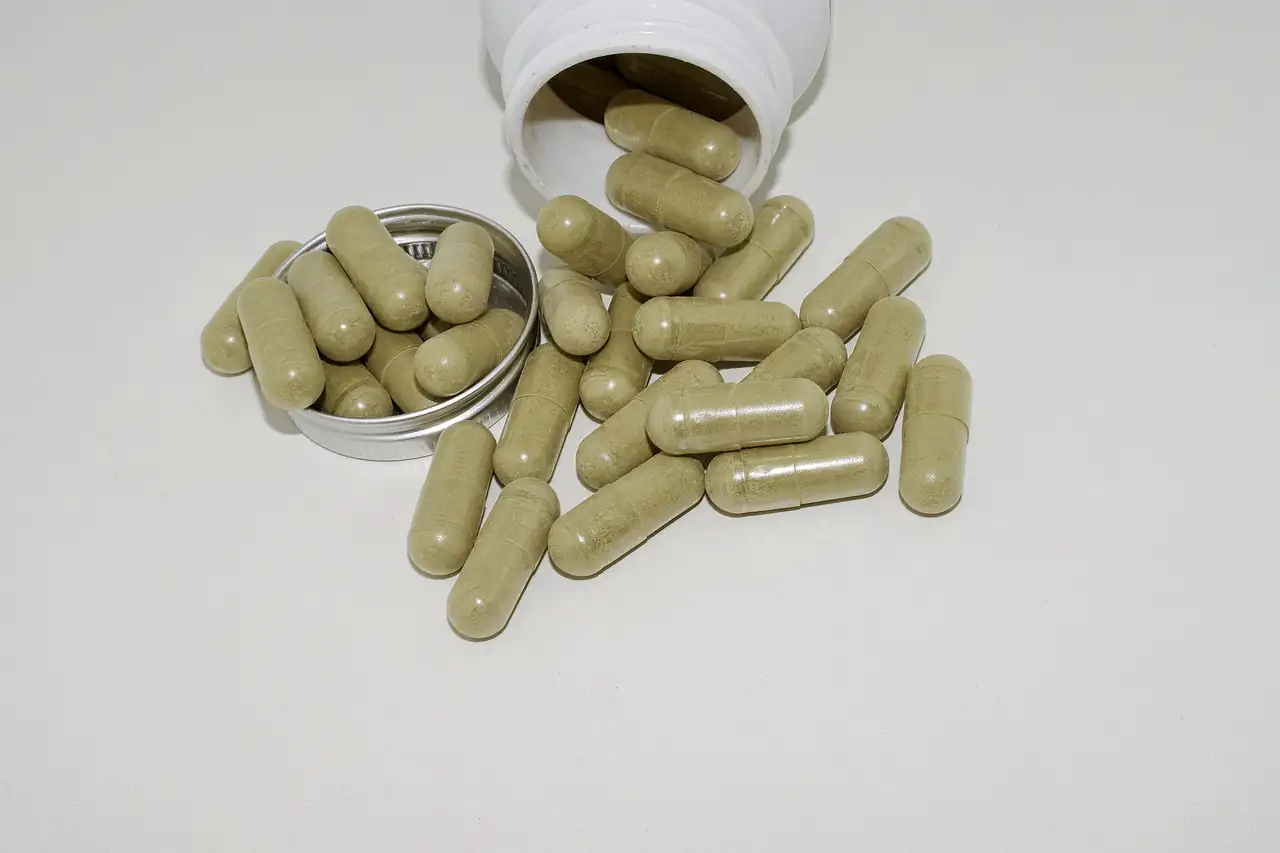 Herbal powder capsules spilling from a small dish