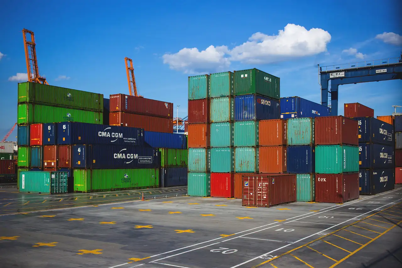Stacked shipping containers in a port yard
