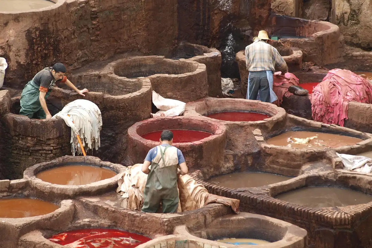 Workers among dye pits in an open-air tannery