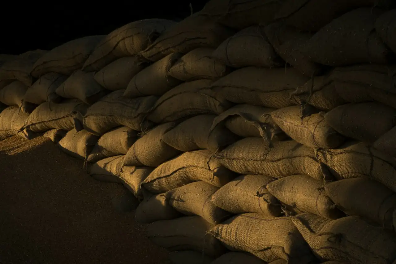 Jute sacks of produce stacked in a dark store