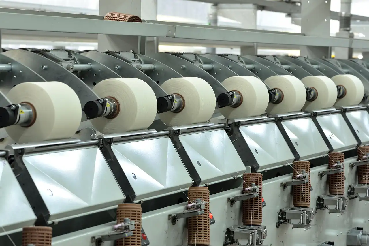 Rows of yarn spools on a spinning machine