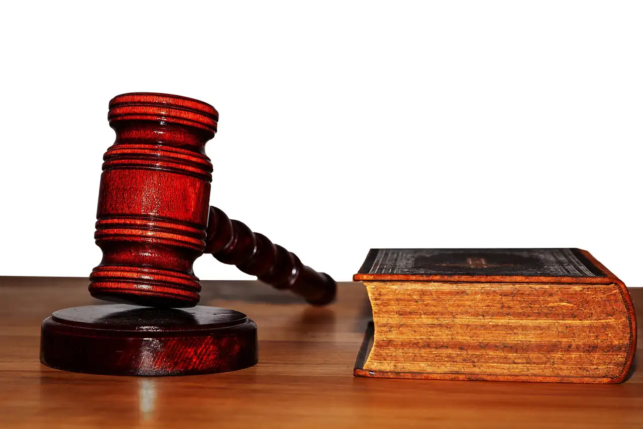 A judge's gavel beside a law book
