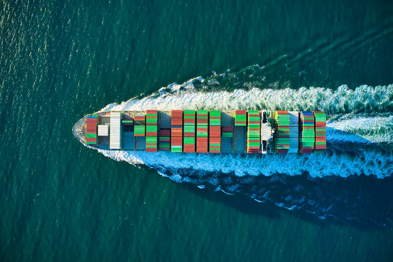 Aerial view of a loaded container ship crossing open water