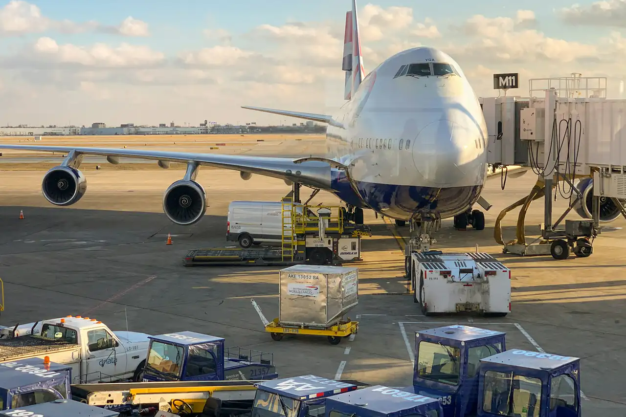 Cargo being loaded onto a wide-body aircraft on an airport apron