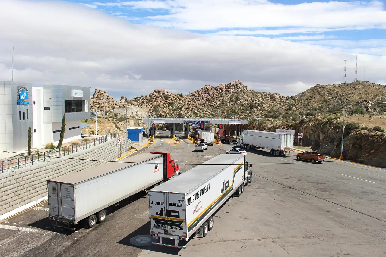 Trucks queued at a checkpoint on a road