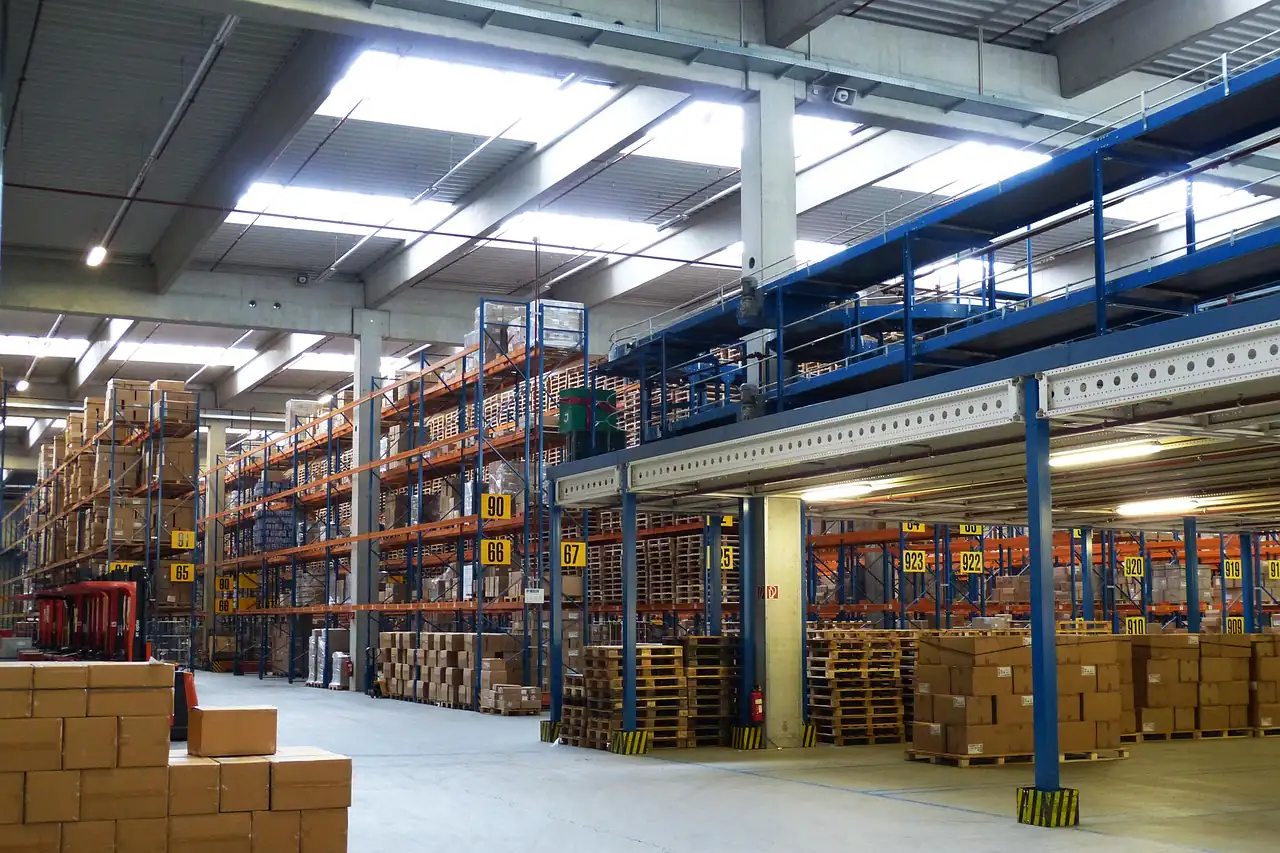 Boxed goods stacked on tall racks inside a warehouse