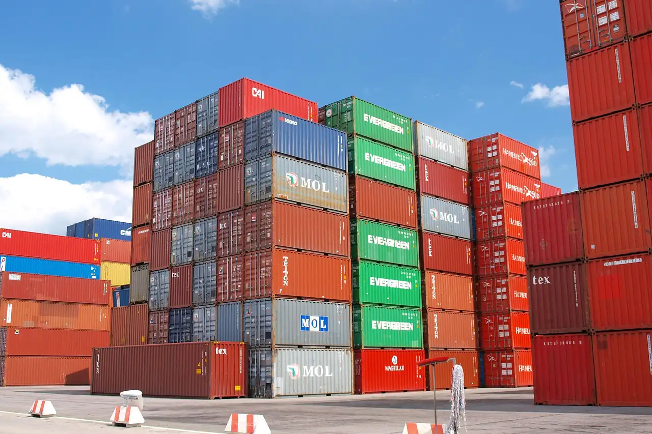 Shipping containers stacked high in a depot yard