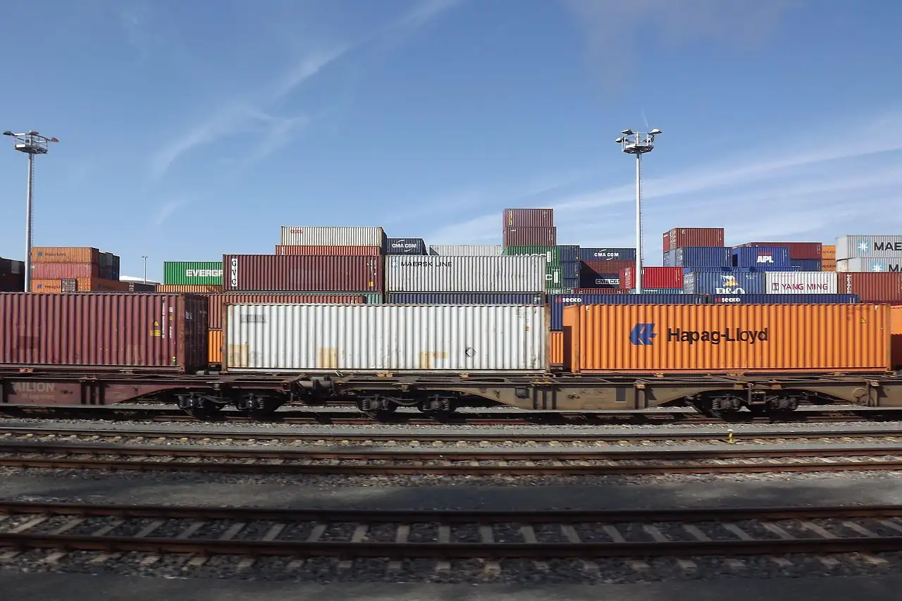 A freight train loaded with containers on a rail line