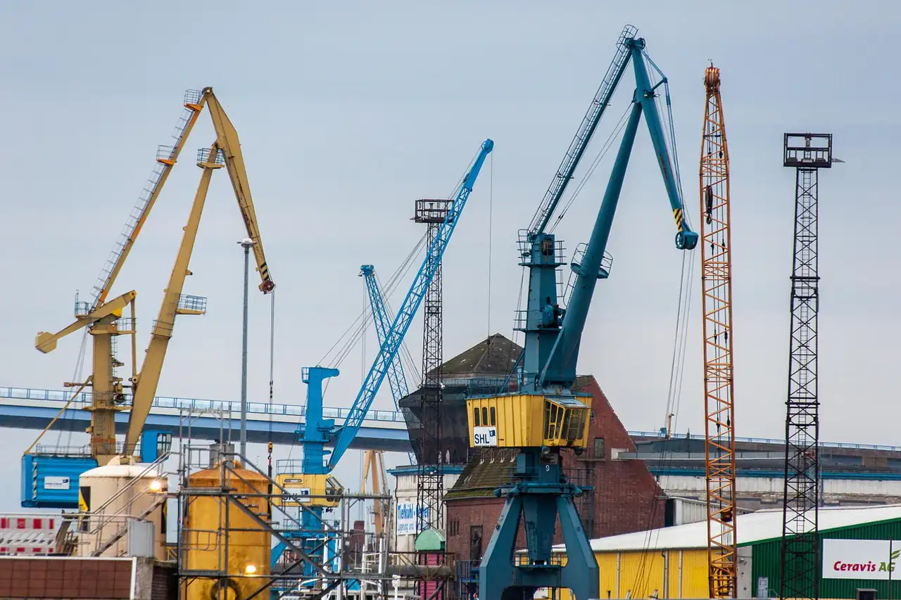 Port cranes standing over a busy quay