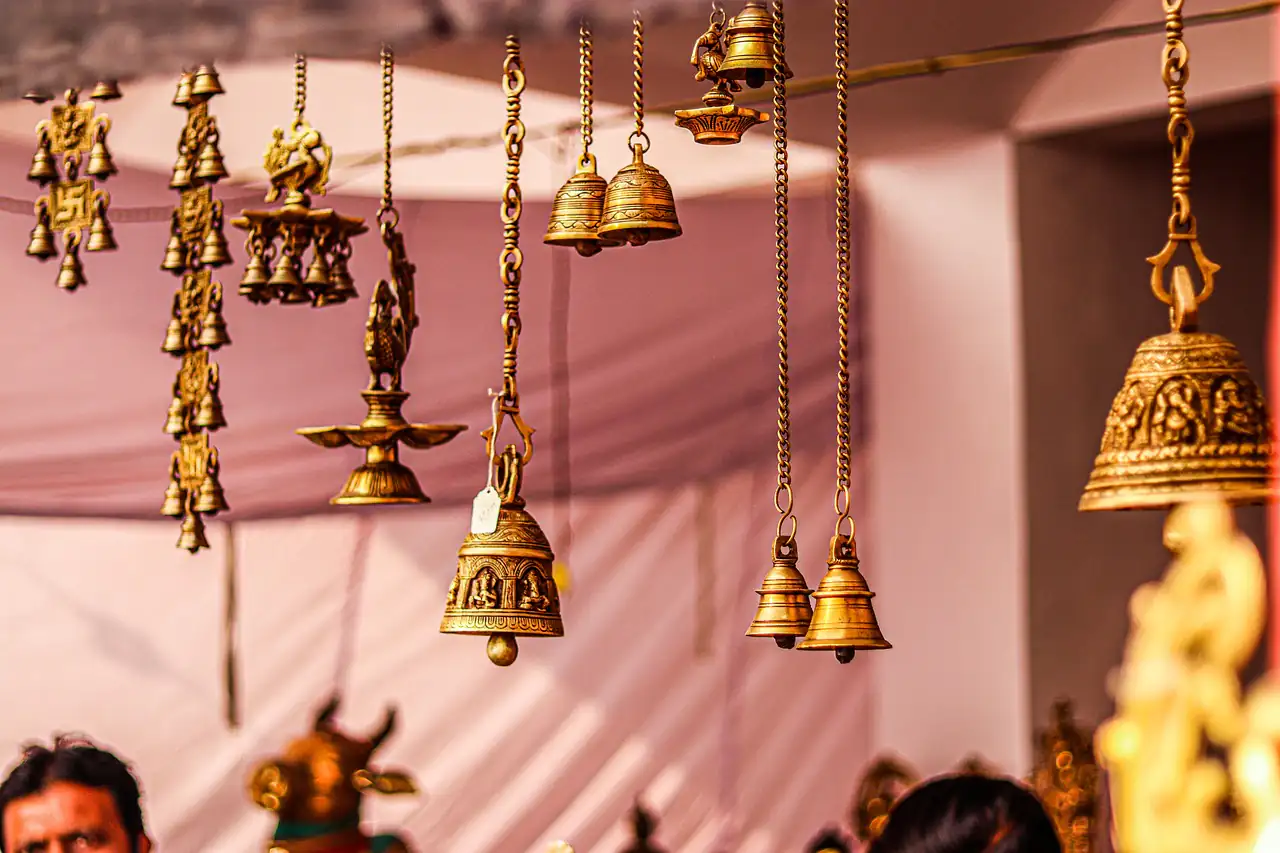Brass bells and lamps hanging in a shop