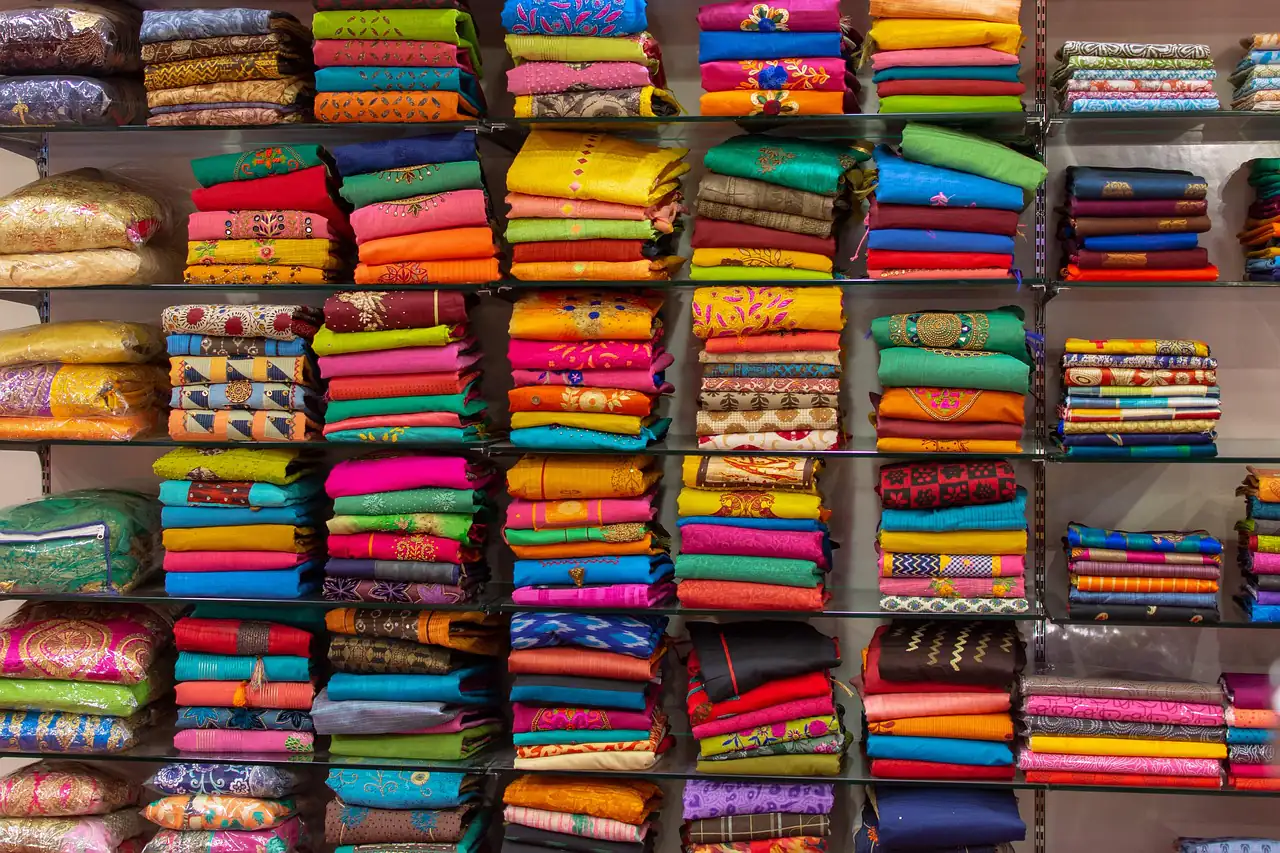 Shelves stacked with sari fabrics