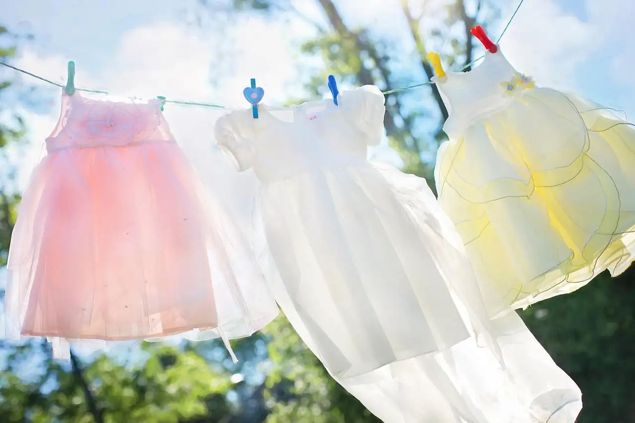 Baby dresses drying on a washing line