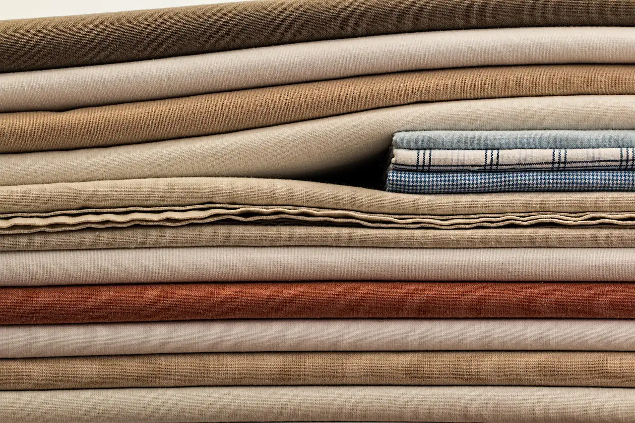 Folded fabric lengths stacked in a pile