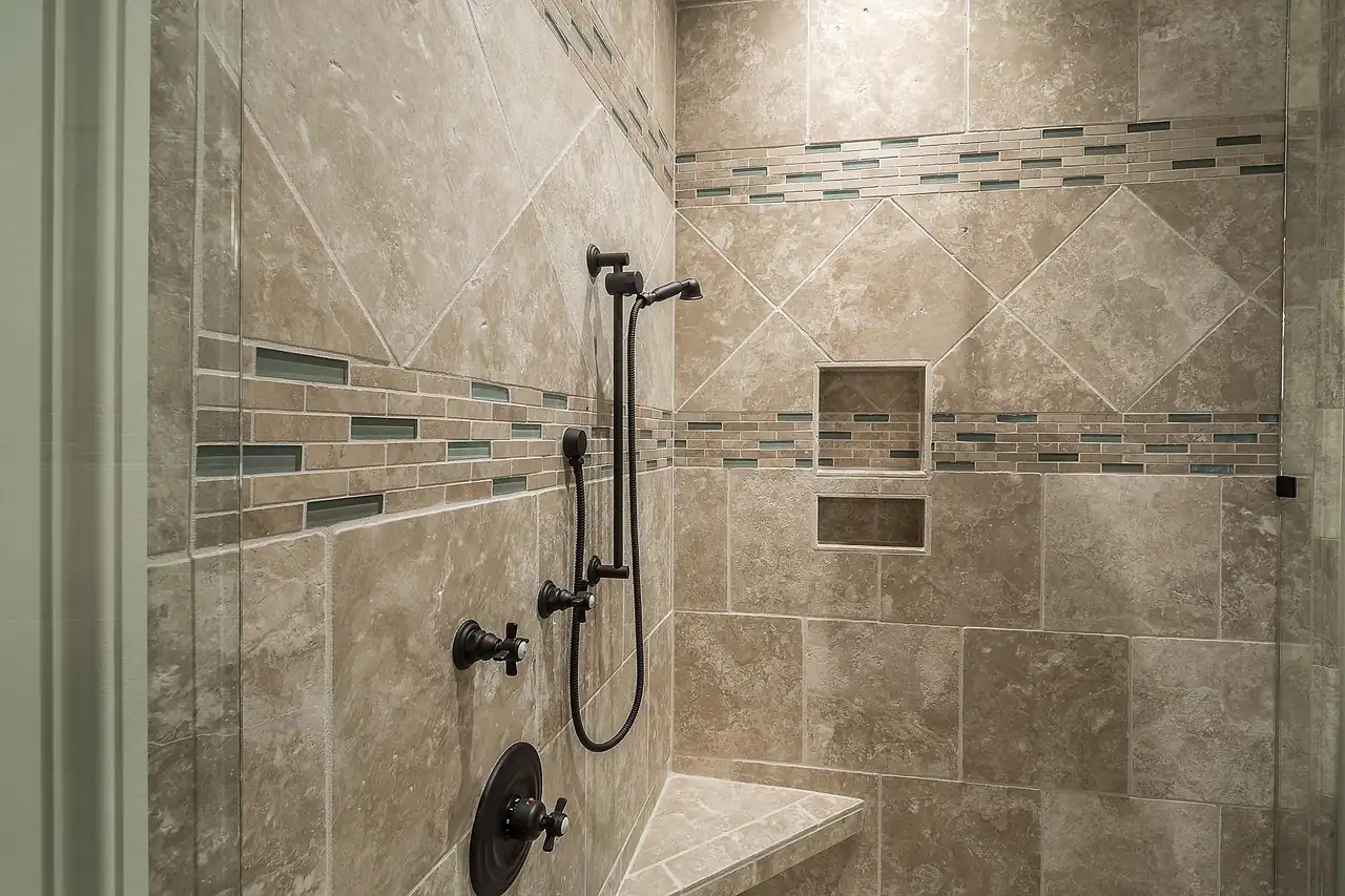 A shower wall finished in ceramic tiles