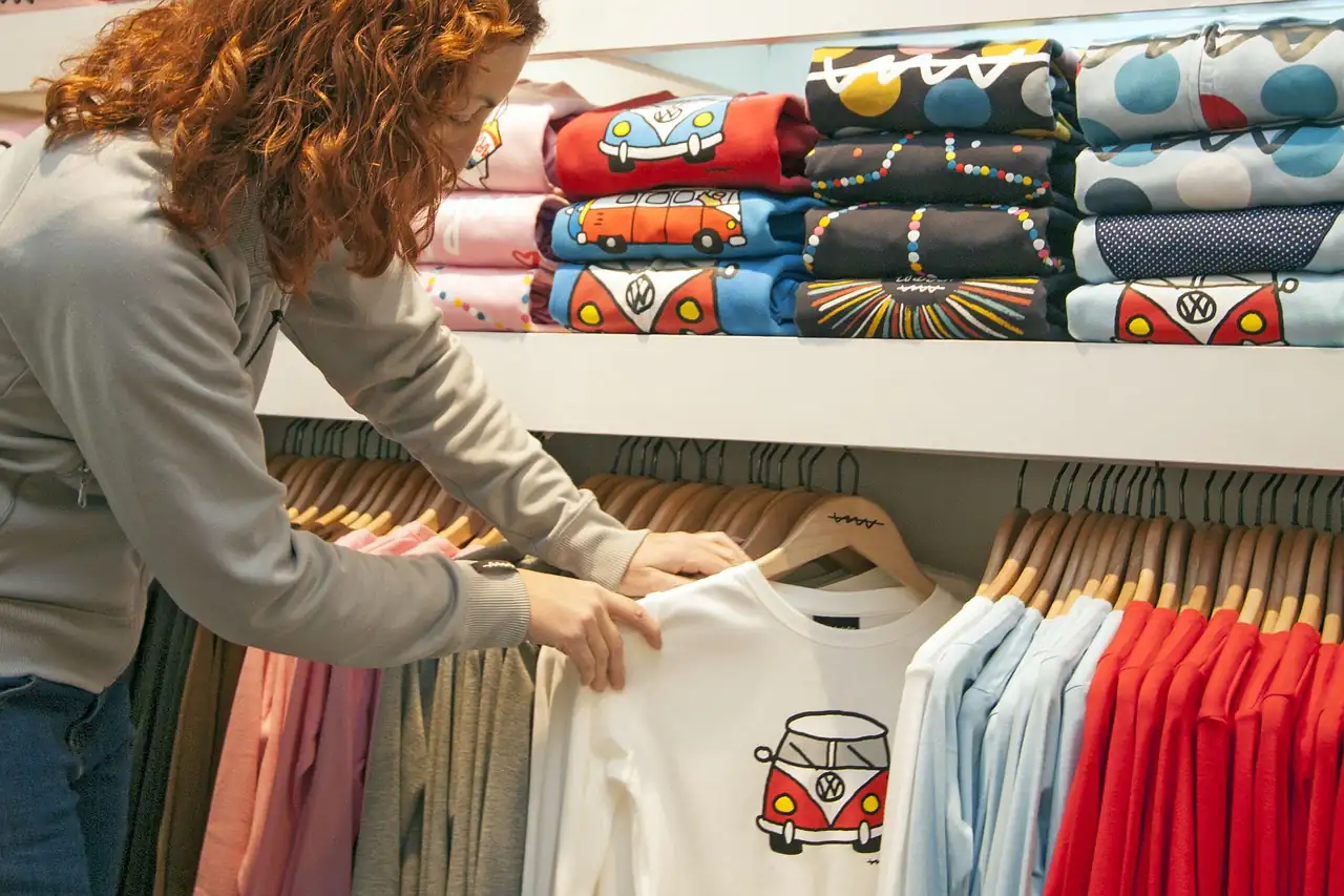 Printed T-shirts on shelves in a shop