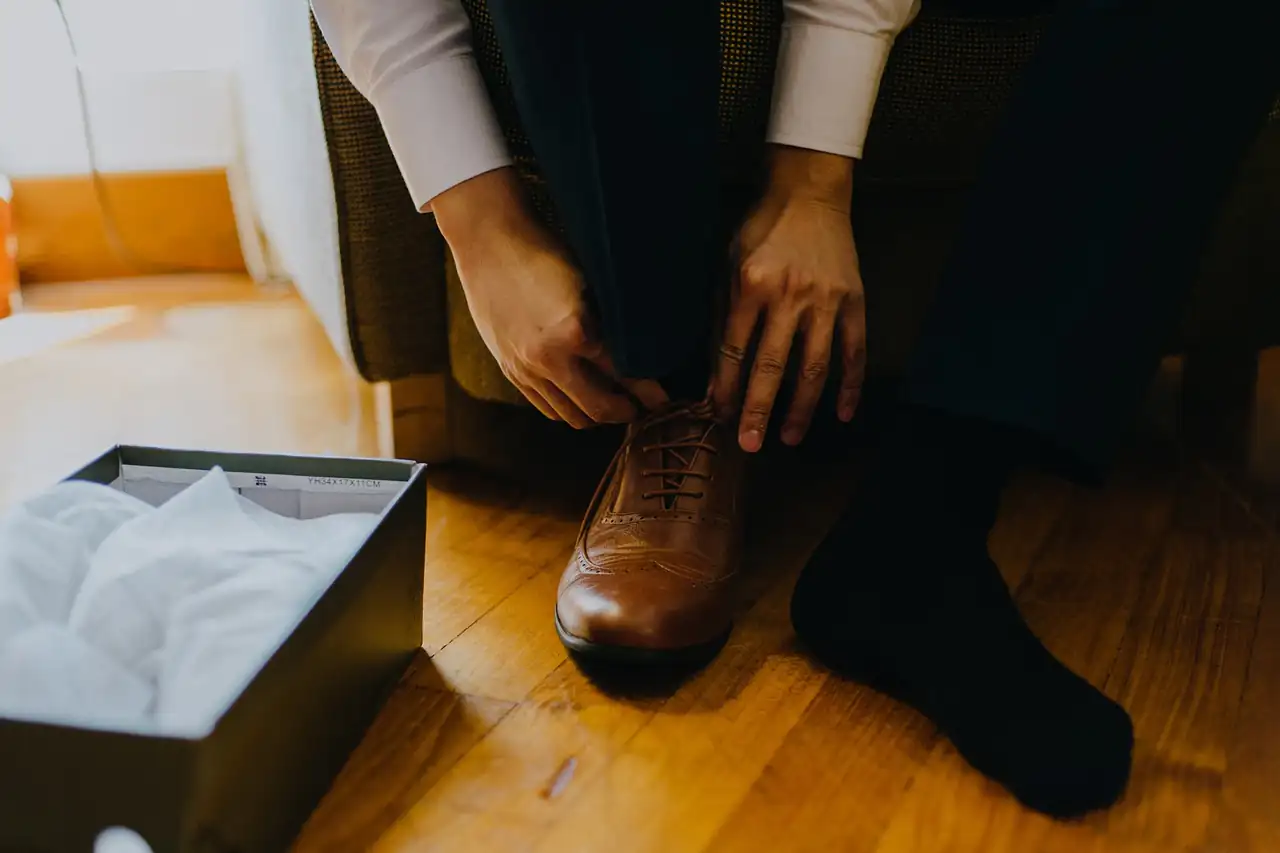 Trying on a new leather shoe by its box