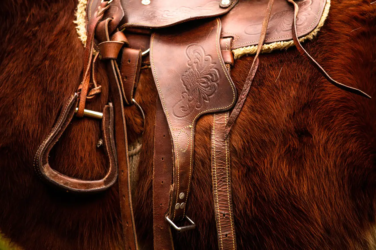 A tooled leather saddle and stirrup leather