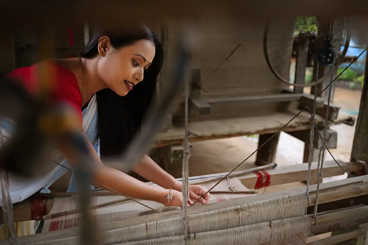 A weaver checking a power loom