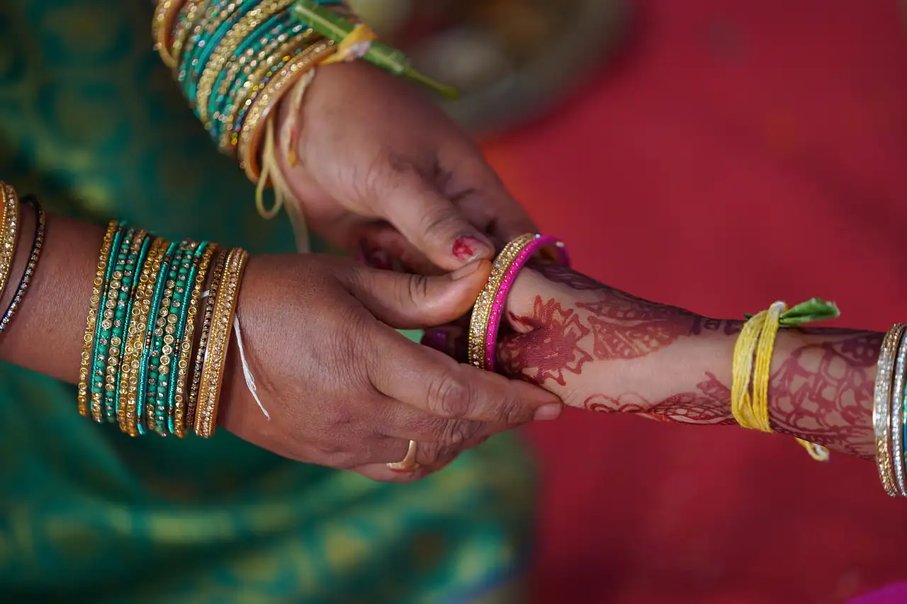 Glass bangles being slipped onto a wrist