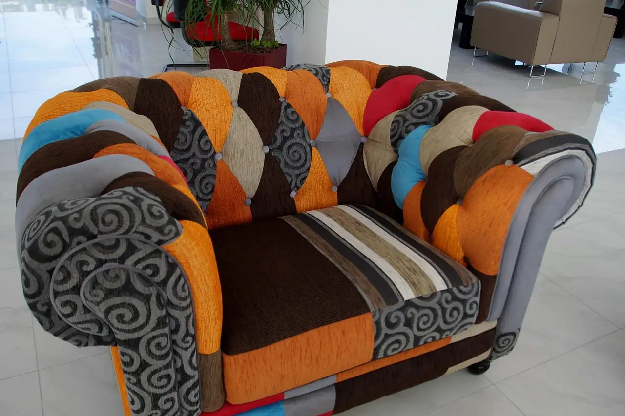 An upholstered armchair in patchwork fabric