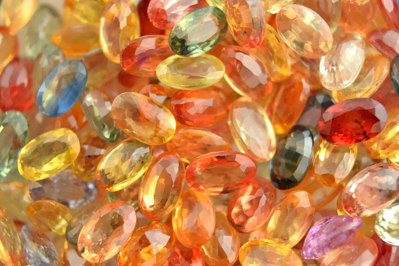 A heap of cut coloured gemstones