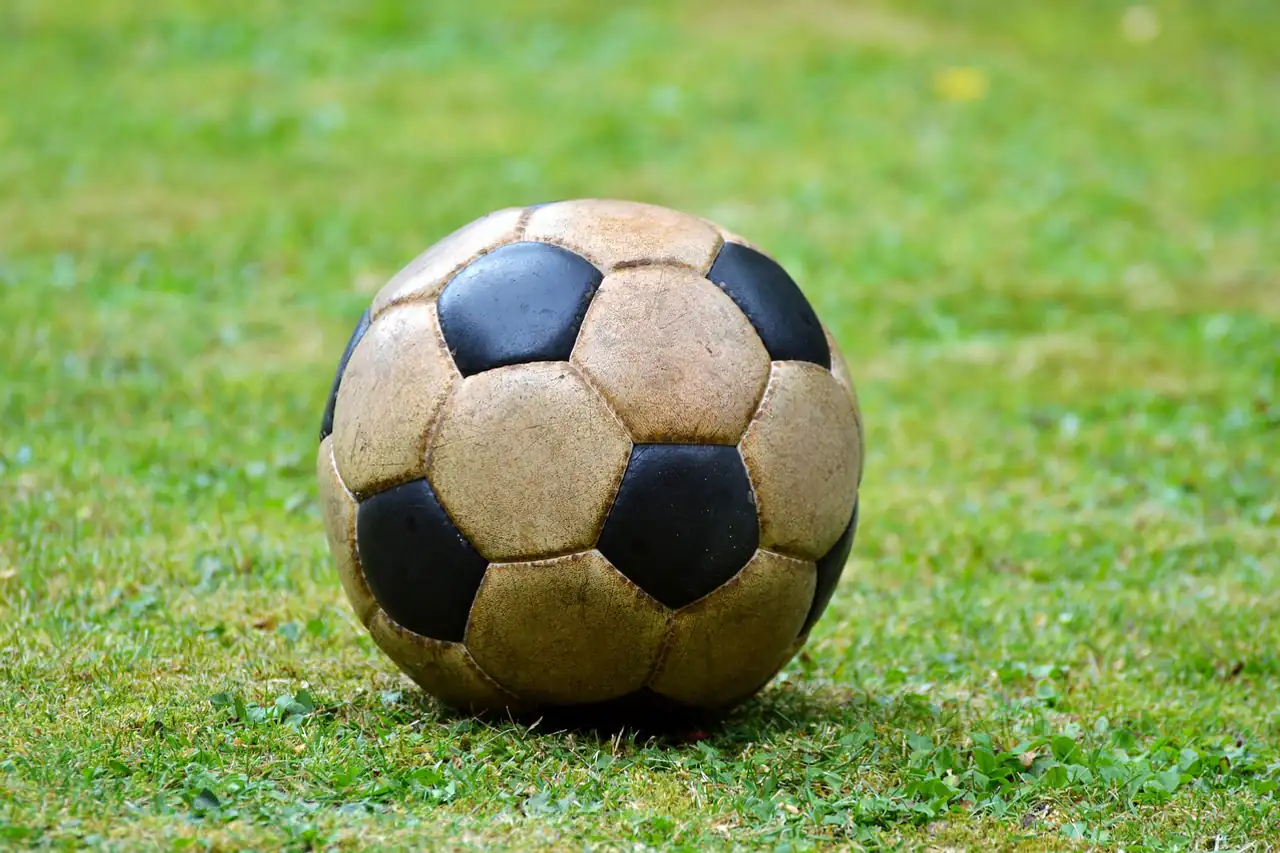 A stitched football on grass