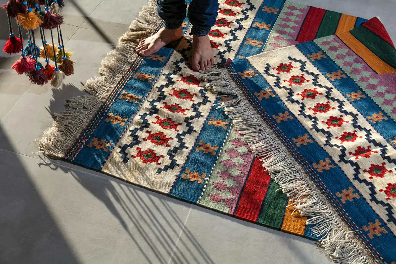 Workers laying out a newly made flatweave rug