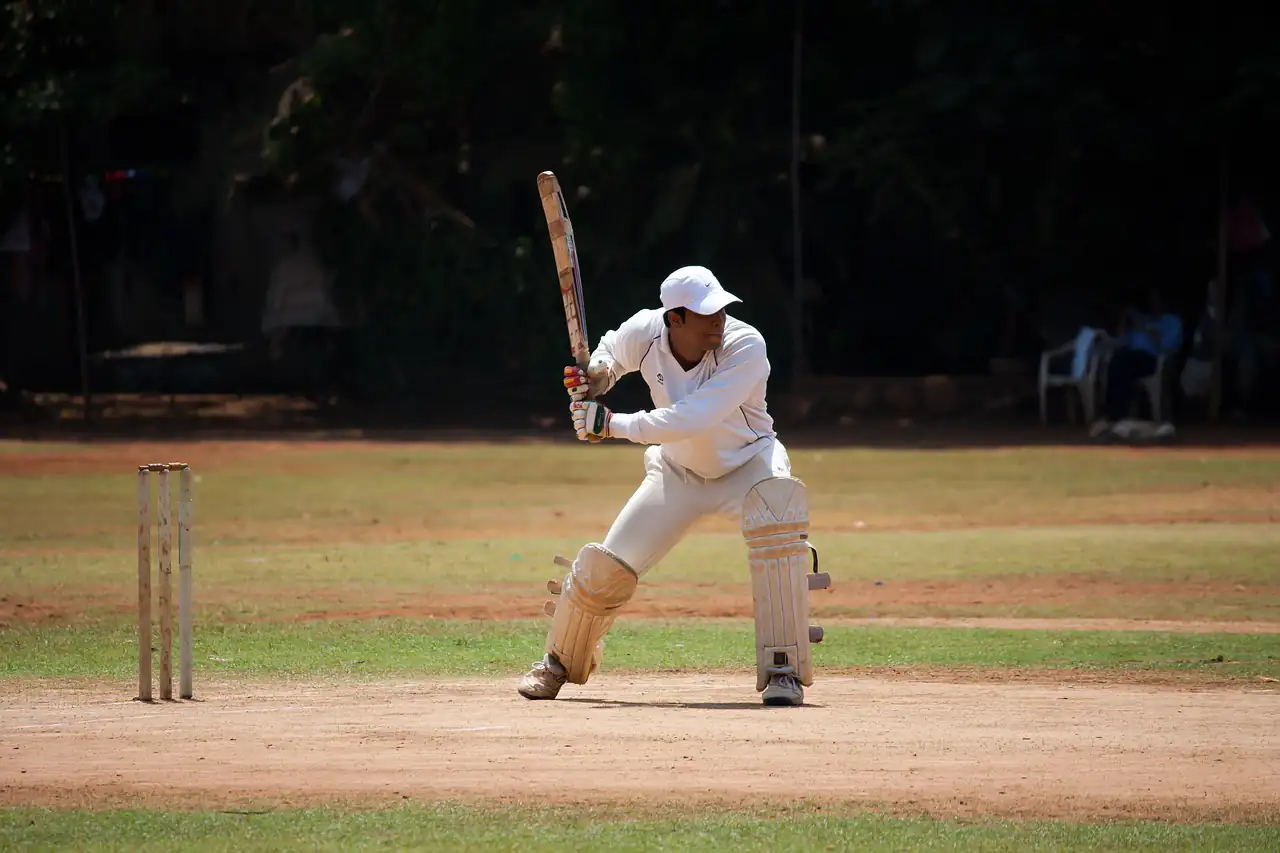 A batsman playing a shot on a cricket pitch