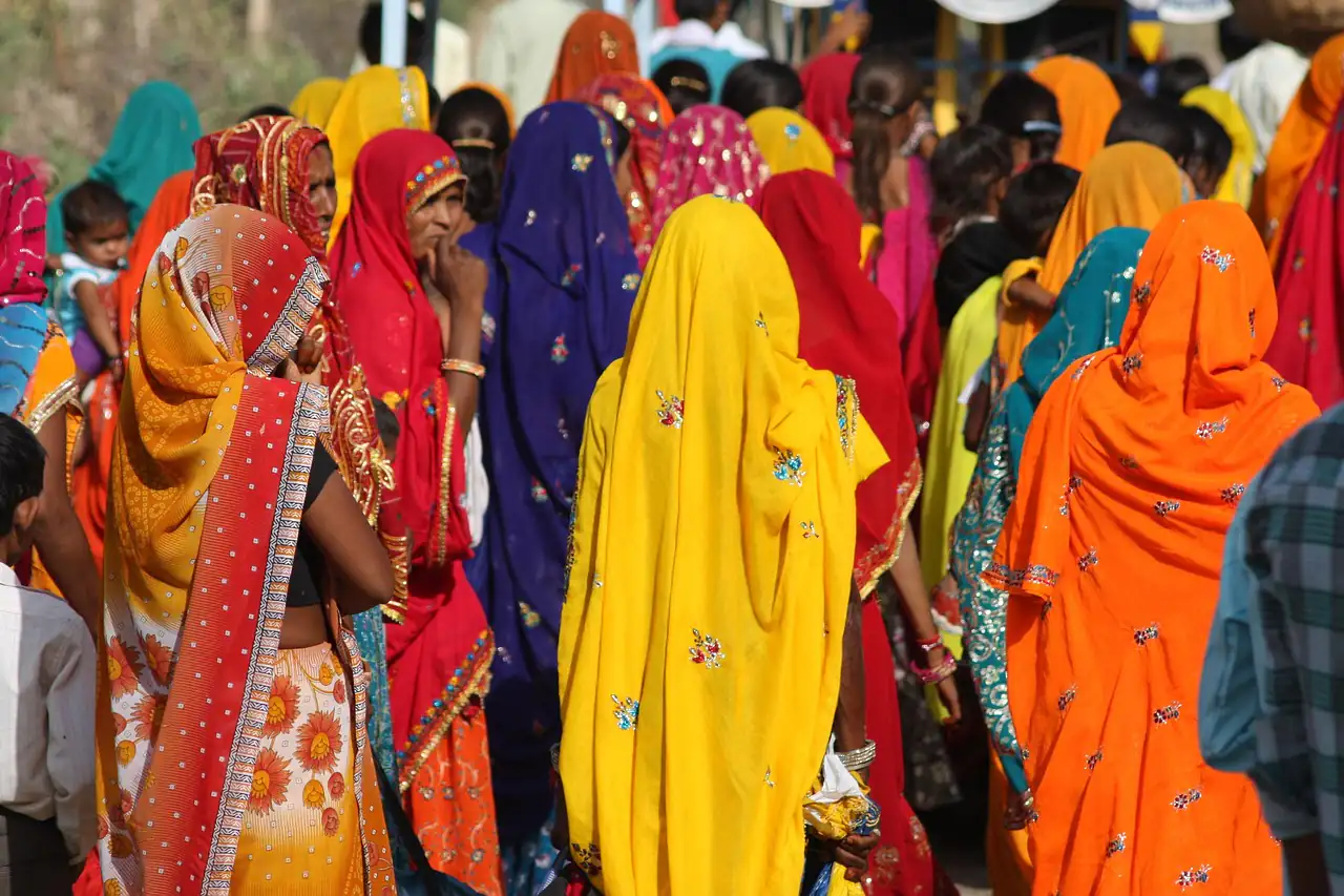Women in brightly coloured saris at a market