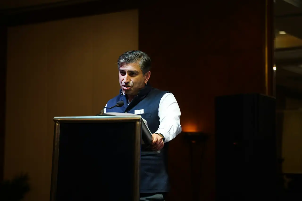 A speaker at a podium at a business event