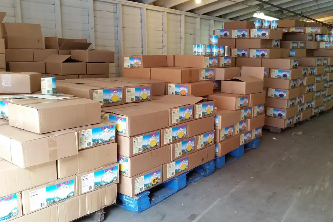 Stacked cartons of stock in a warehouse