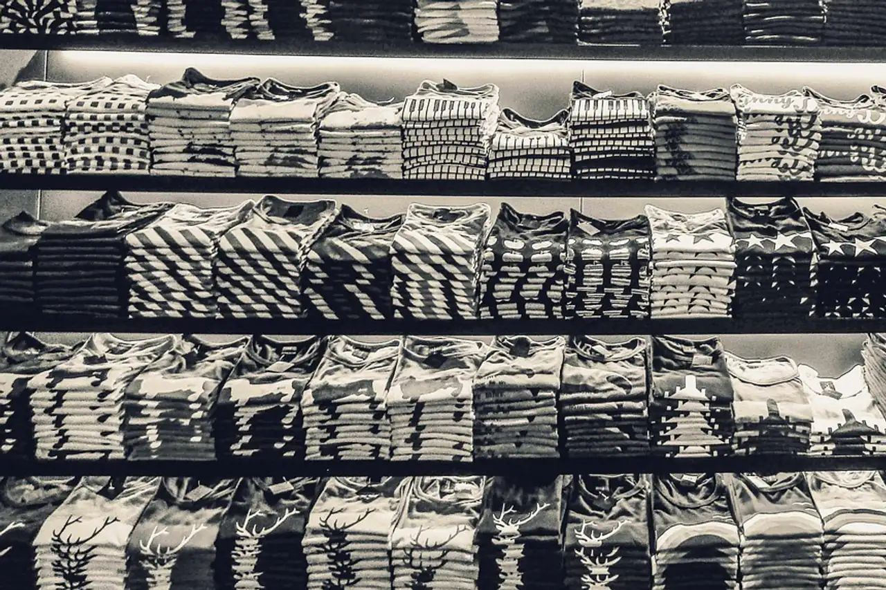 Folded T-shirts stacked on shelves