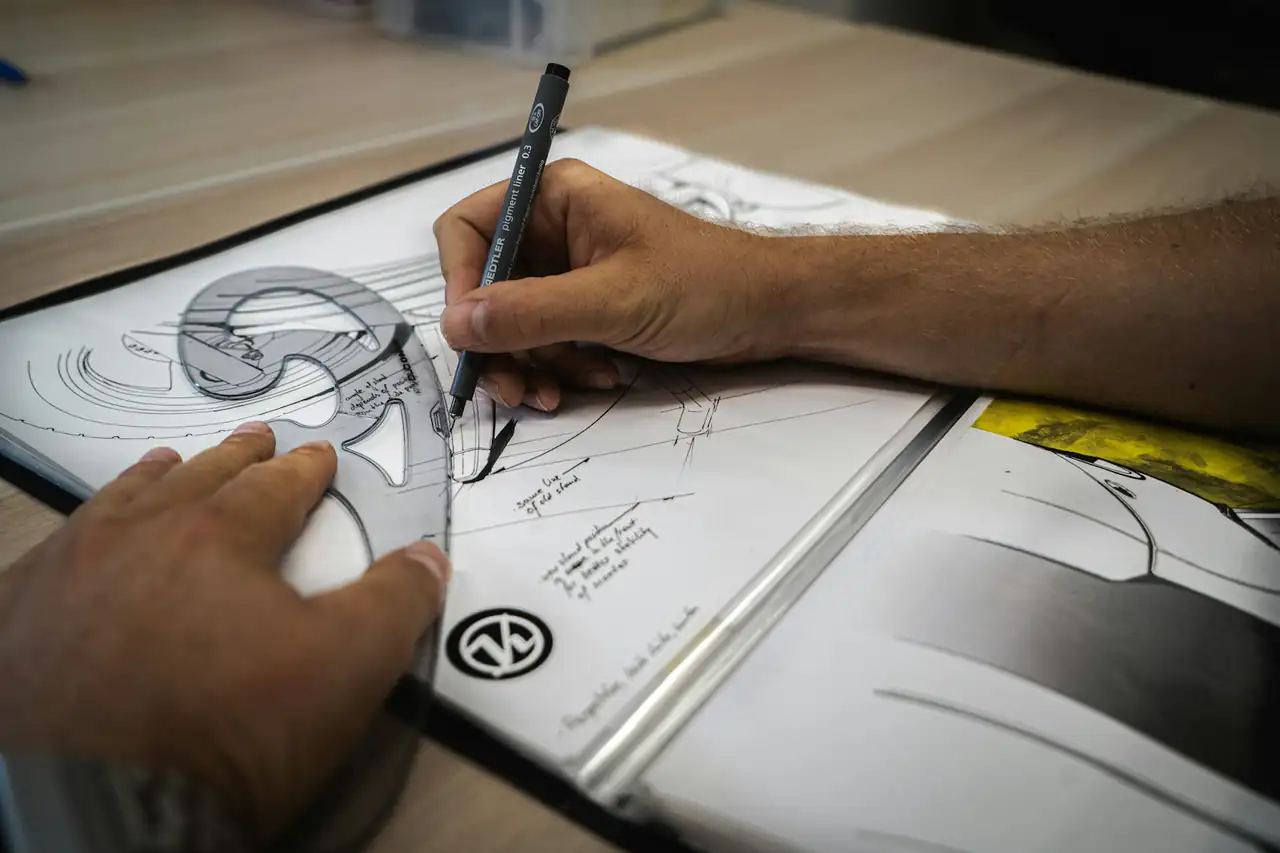 A designer sketching a product drawing by hand