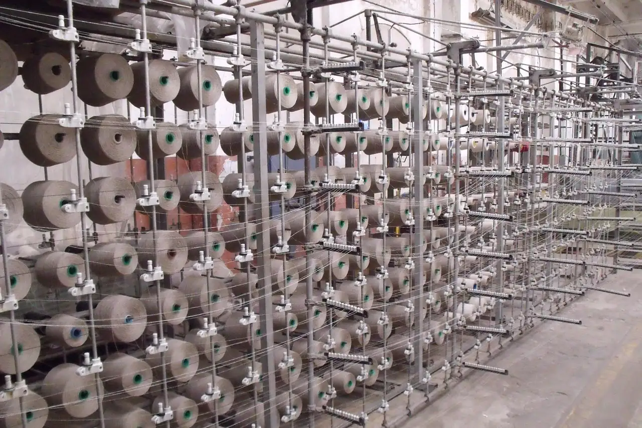 Rows of yarn cones on a spinning mill frame