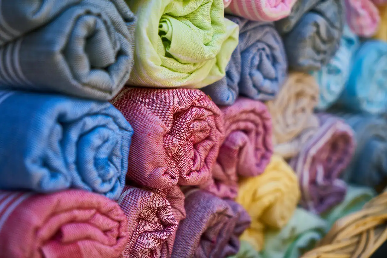 Rolled cotton scarves stacked in a textile shop