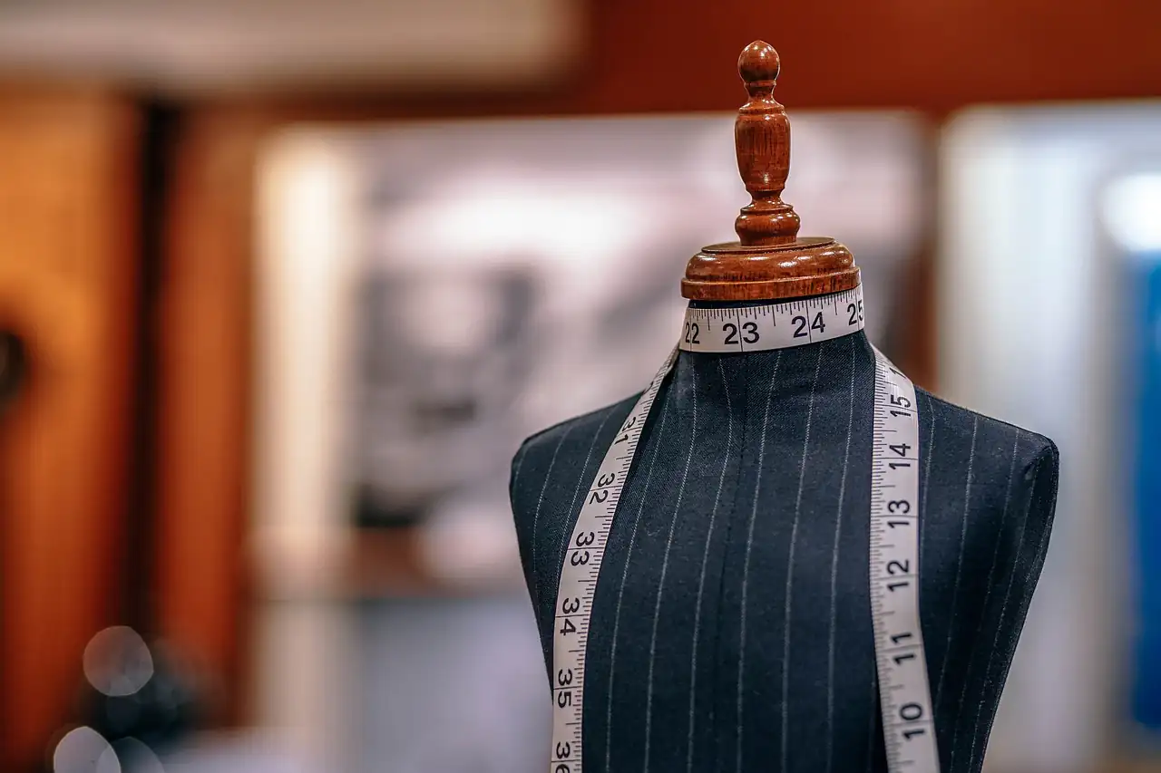 A measuring tape over a jacket on a tailor's dummy