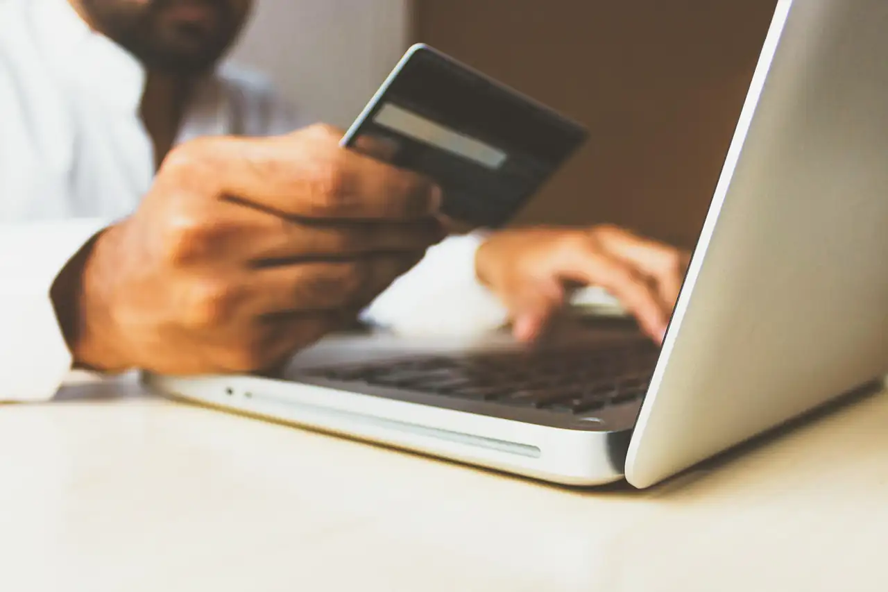 Paying online with a card at a laptop