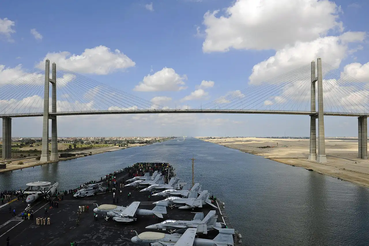 A ship passing under a bridge on the Suez Canal