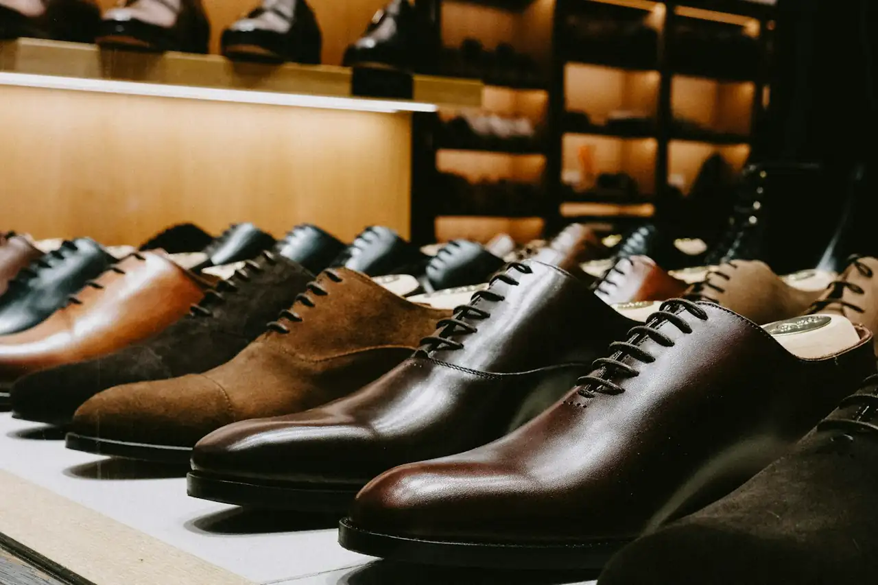 Leather shoes lined up on a display shelf
