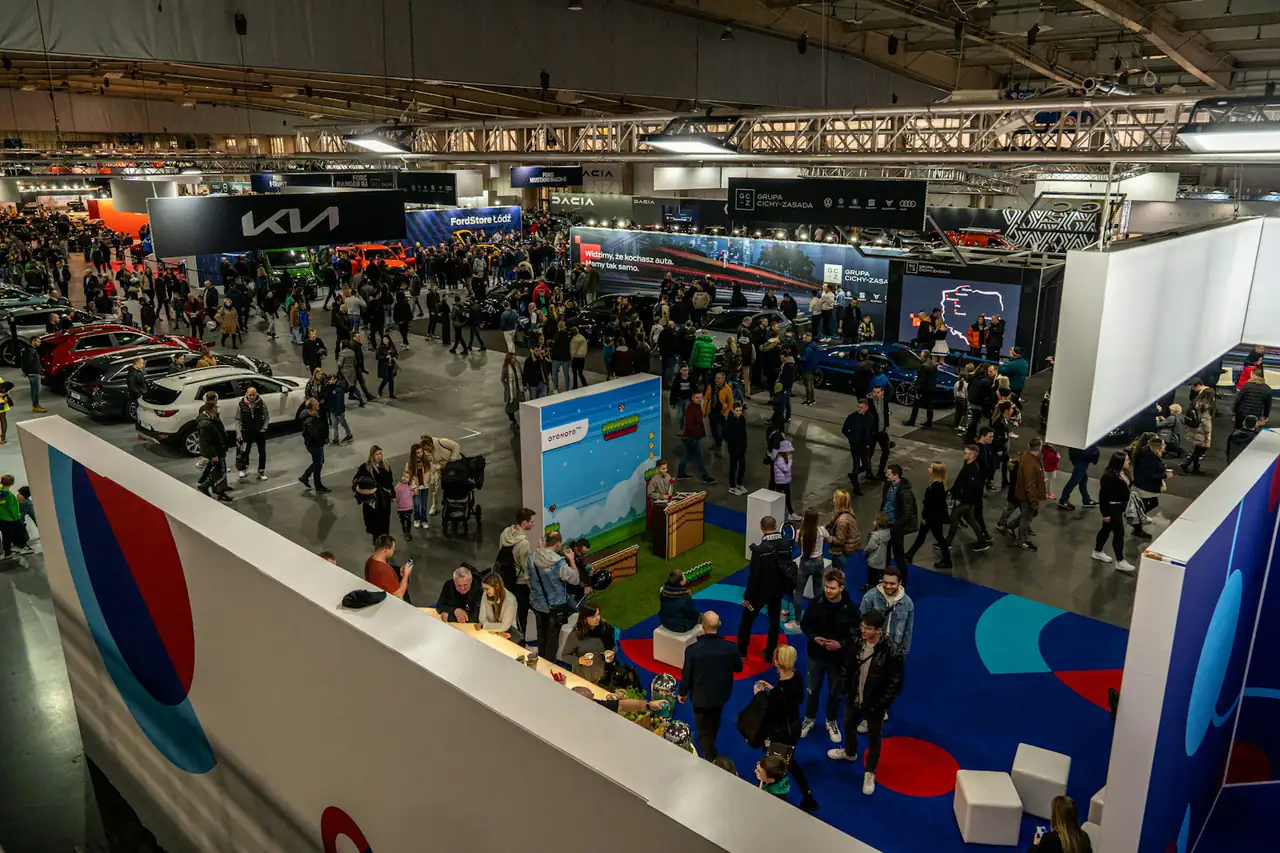 Visitors crowding car stands at a motor show